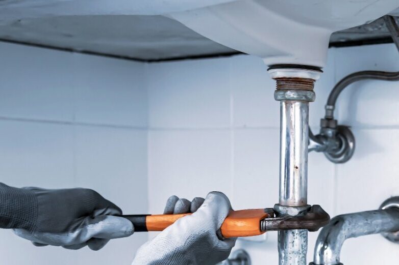 a plumber repairing a pipe